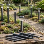 A garden path scene with solar pathway lights raised on matte charcoal-gray 3D printed riser stakes at different heights above low planting, original